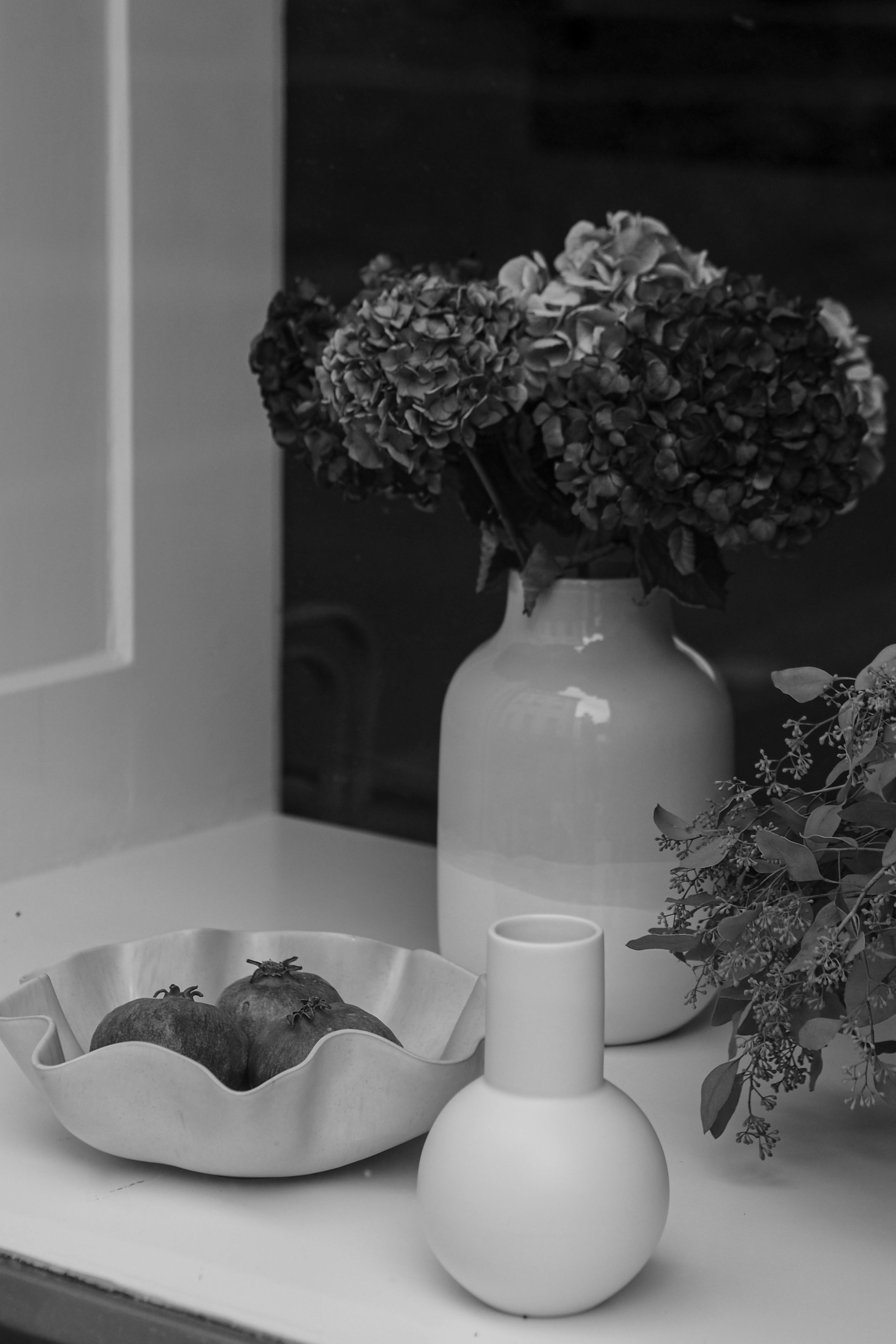 handmade ceramic vase with minimalist white finish and floral arrangement