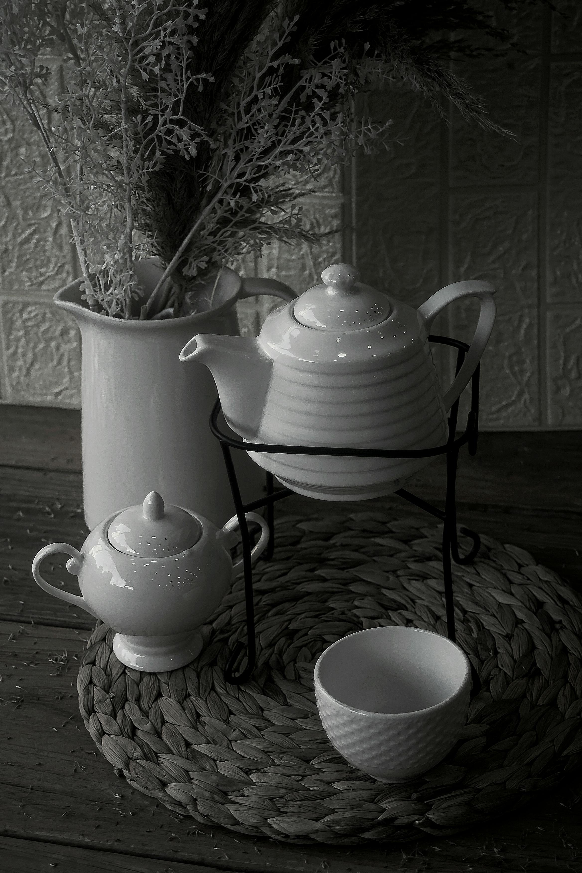 handcrafted ceramic tea pot and matching cup set by pearlkiln in soft natural lighting